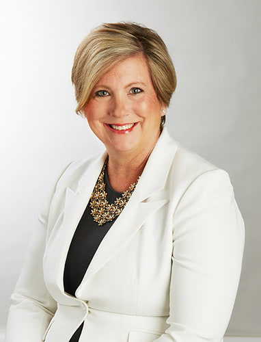 Portrait of a woman in a white suit.